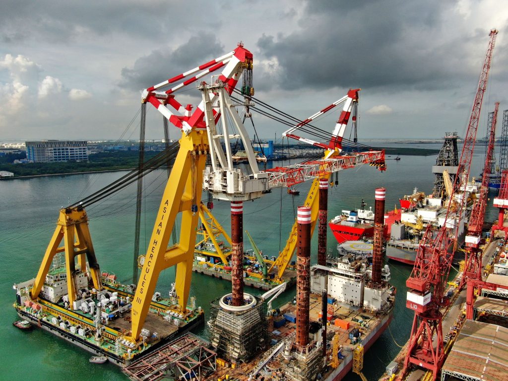 Cranes lifting a crane aboard Bold Tern in Singapore